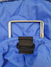 Close-up of a blue bag with a handle and black strap