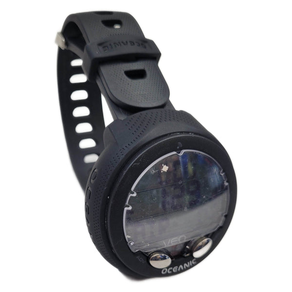 Black diving computer watch with digital display on a white background